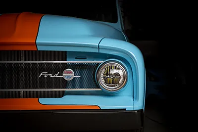 High-Resolution Photo: Blue Ford F100 Pickup Emerging from the Dark