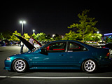Side of Teal Honda Civic Coupe at Night