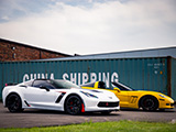 Pair of Chevy Corvettes next to Shipping Container