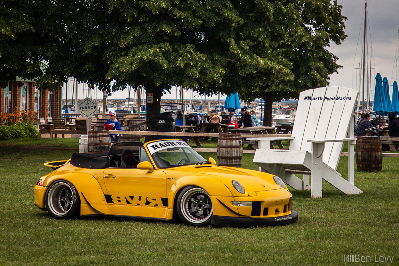 Yellow RWB Porsche 911 next to Gian Chair at North Point Marina