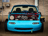 Beat Up Miata that's been spraypainted blue
