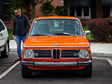 Front of Orange BMW 2002 at a Cars & Coffee in Illinois
