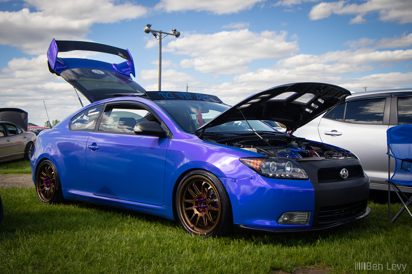 Purple Scion tC in the grass at Rockford Speedway