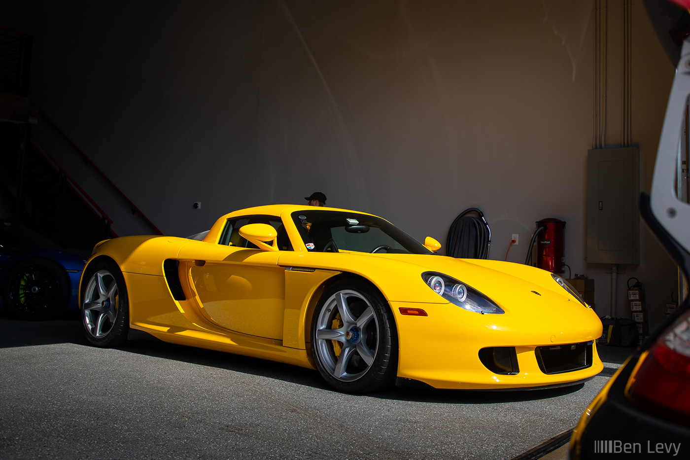 Yellow Porsche Carrera GT in Big Door Garage
