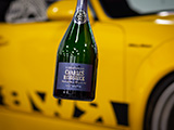 Bottle of Charles Heidsieck Champagne in front of Yellow RWB