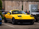 Yellow and Black Mazda Miata with Sleepy Headlights