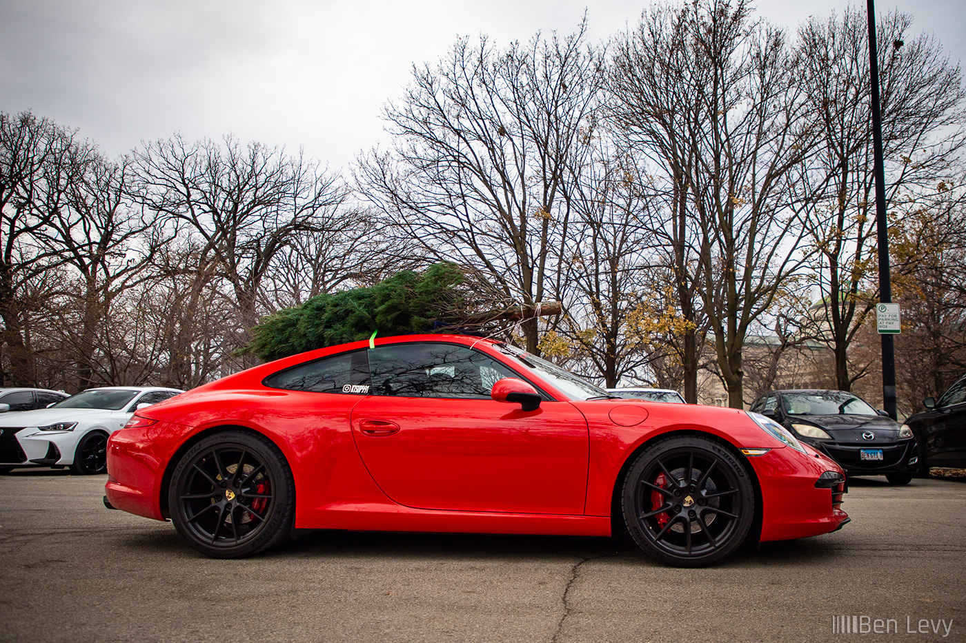 Red Porsche 911 Carrera S with Christmas Tree on Roof