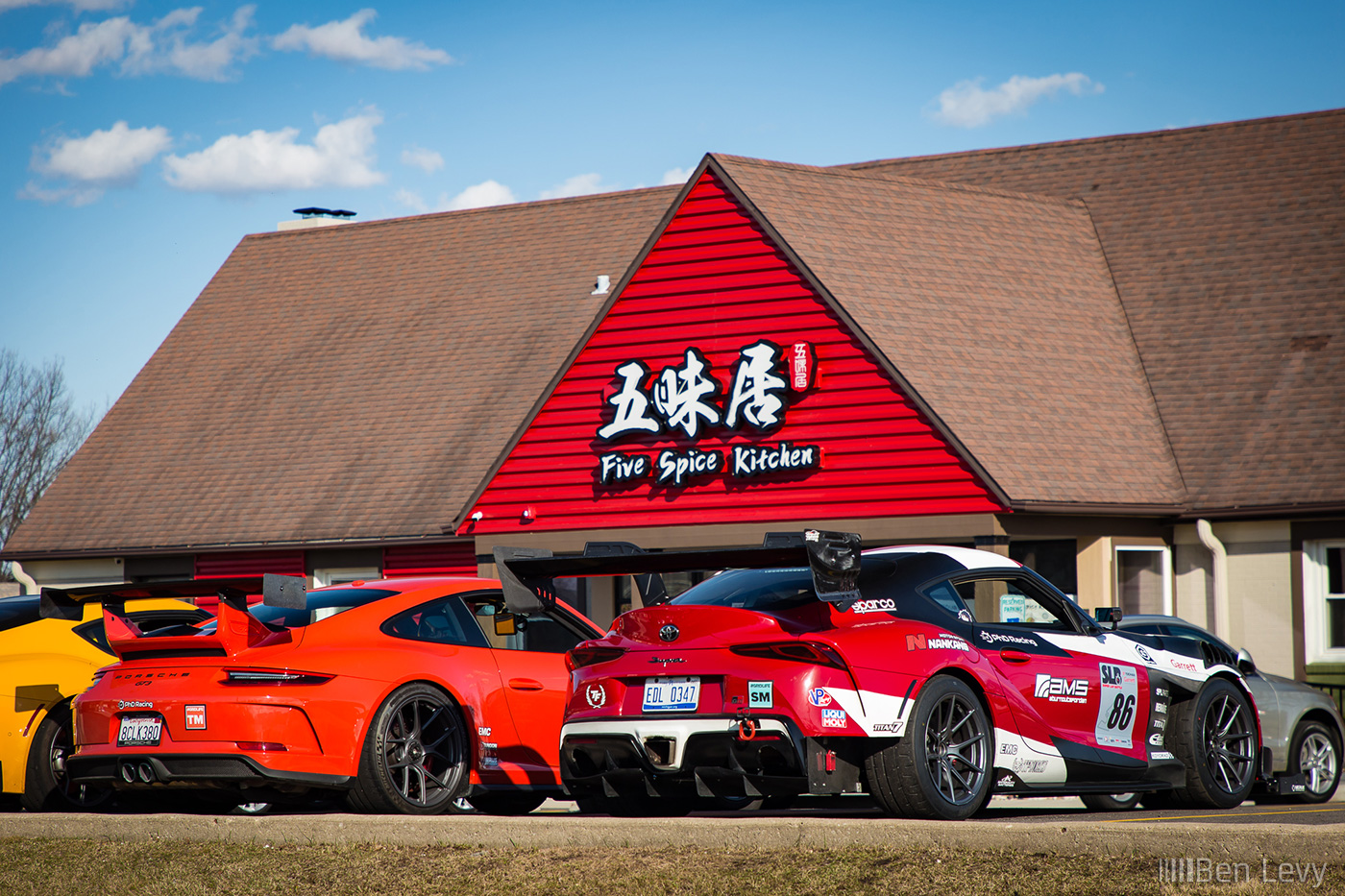 Porsche 911 GT3 and Toyota Supra GR outside of Five Spice Kitchen