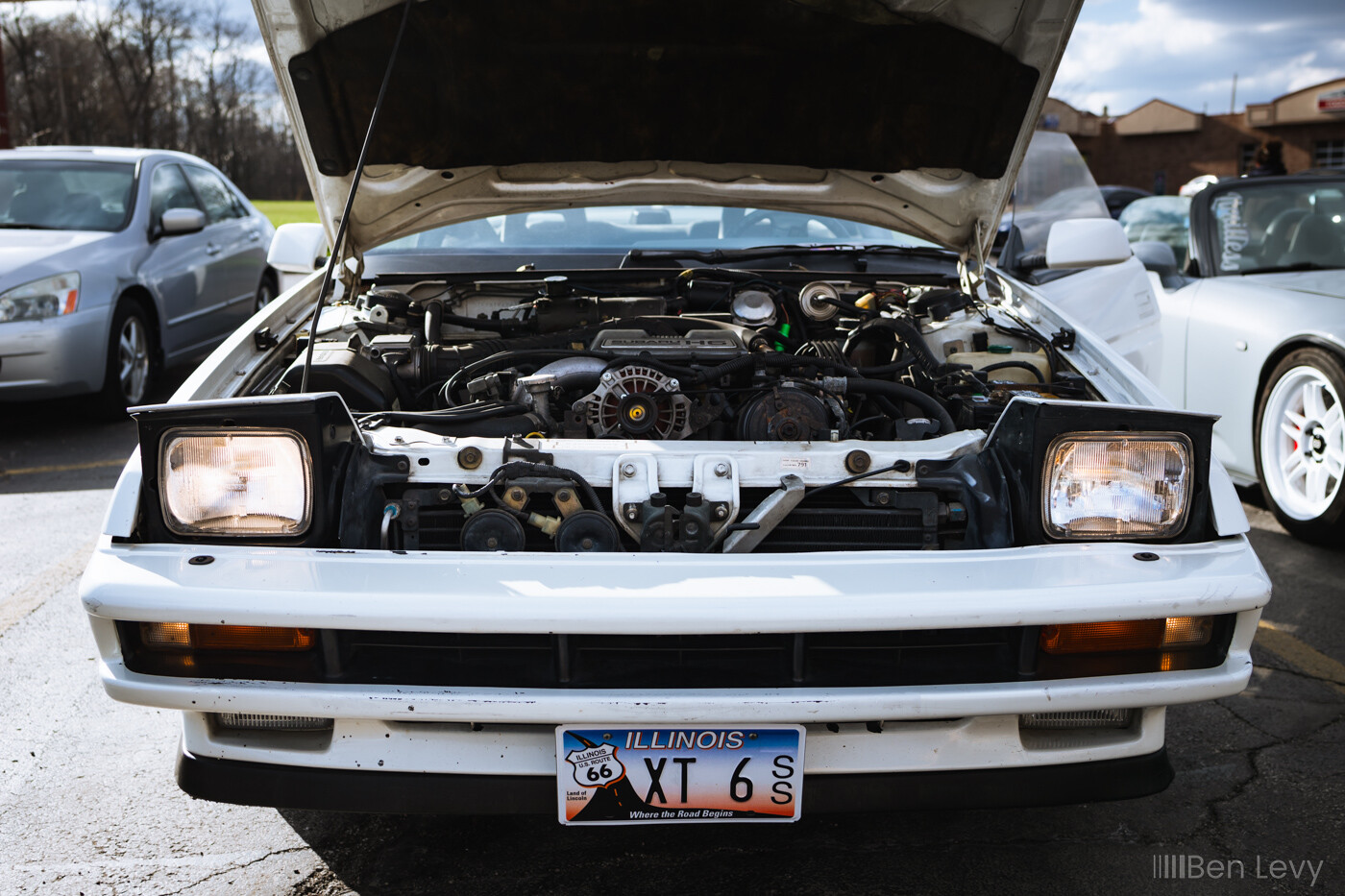 Pop Up Headlights on a White Subaru XT 6