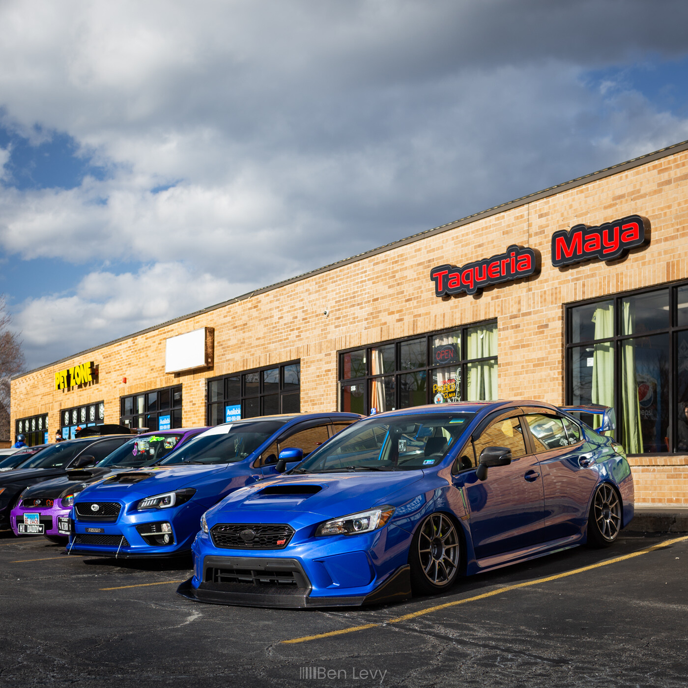 Blue Subarus parked outside of Taqueria Maya