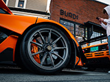Wheel of Orange McLaren P1 LM in front of Burdi Clothing in Hinsdale
