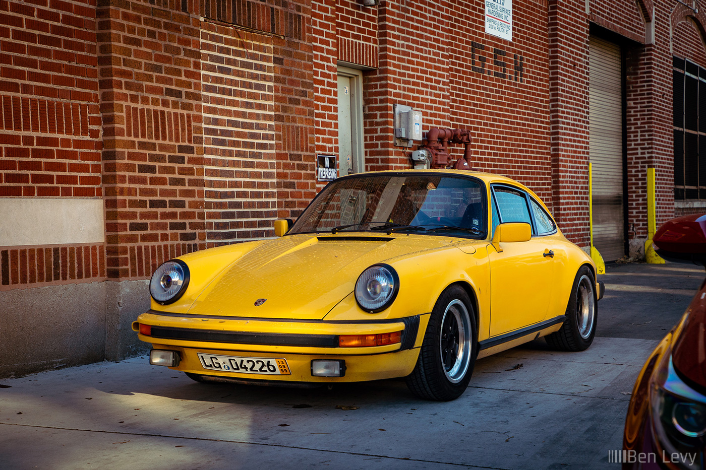 Yellow Porsche 911 on a Fulton St Sidewalk