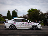 Cherry Blossom Subaru WRX driving through parking lot