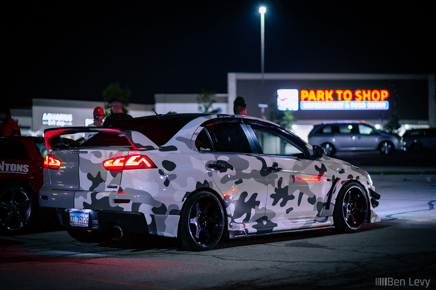 Camoflauge Wrapped Lancer Evo X in Parking Lot at Night