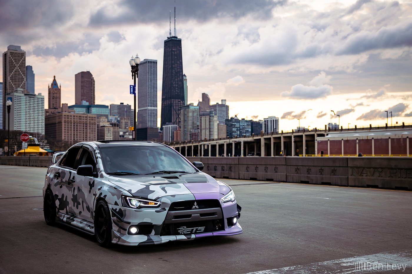 Camouflage and purple Lancer Evolution against the Chicago Skyline