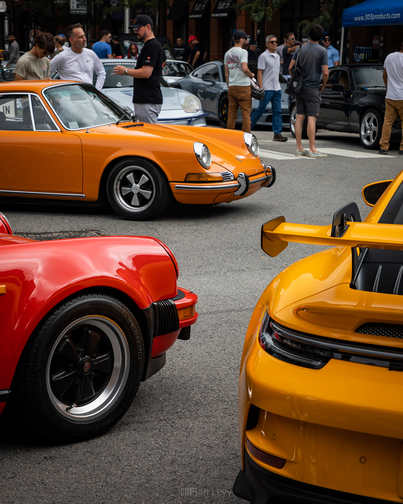 Trio of Red, Orange, and Yellow Porsche 911s from Different Eras