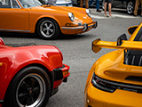 Trio of Red, Orange, and Yellow Porsche 911s from Different Eras