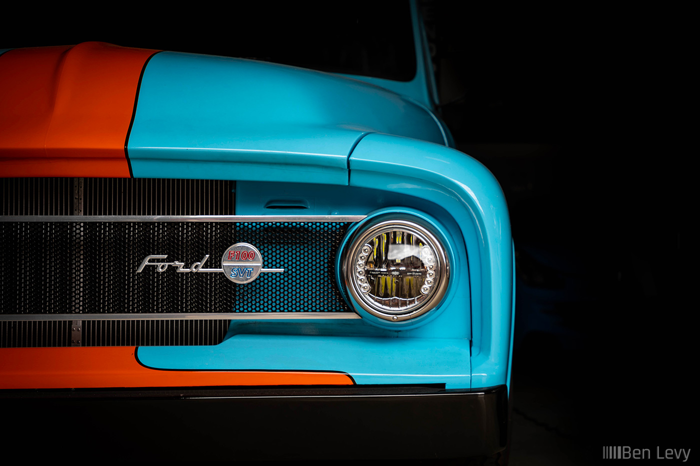 Blue Ford F100 Pickup Emerging from the Dark
