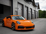 Oraneg Porsche 911 Sport Classic in front of luxory garage condos