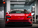 Red Taycan GTS Sport Turismo in a Porsche Dealership