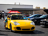 Kid Looking Into a Yellow 996 TT