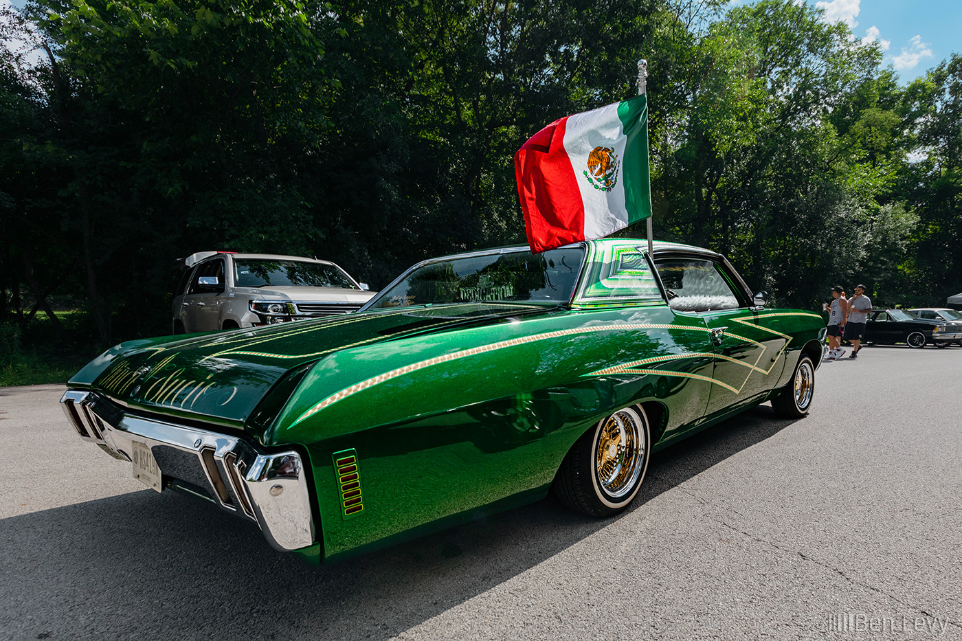 Green Two-Door Chevrolet Caprice with Mexican Flag Waving