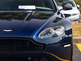 Close-up Shot of the Headlight of a Dark Blue Aston Martin Vantage