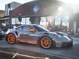 Grey Porsche 992 GT3 RS in front of Burdi Clothing