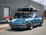 Iris Blue Porsche 911 Cabriolet leaving Checkeditout Chicago in 2024