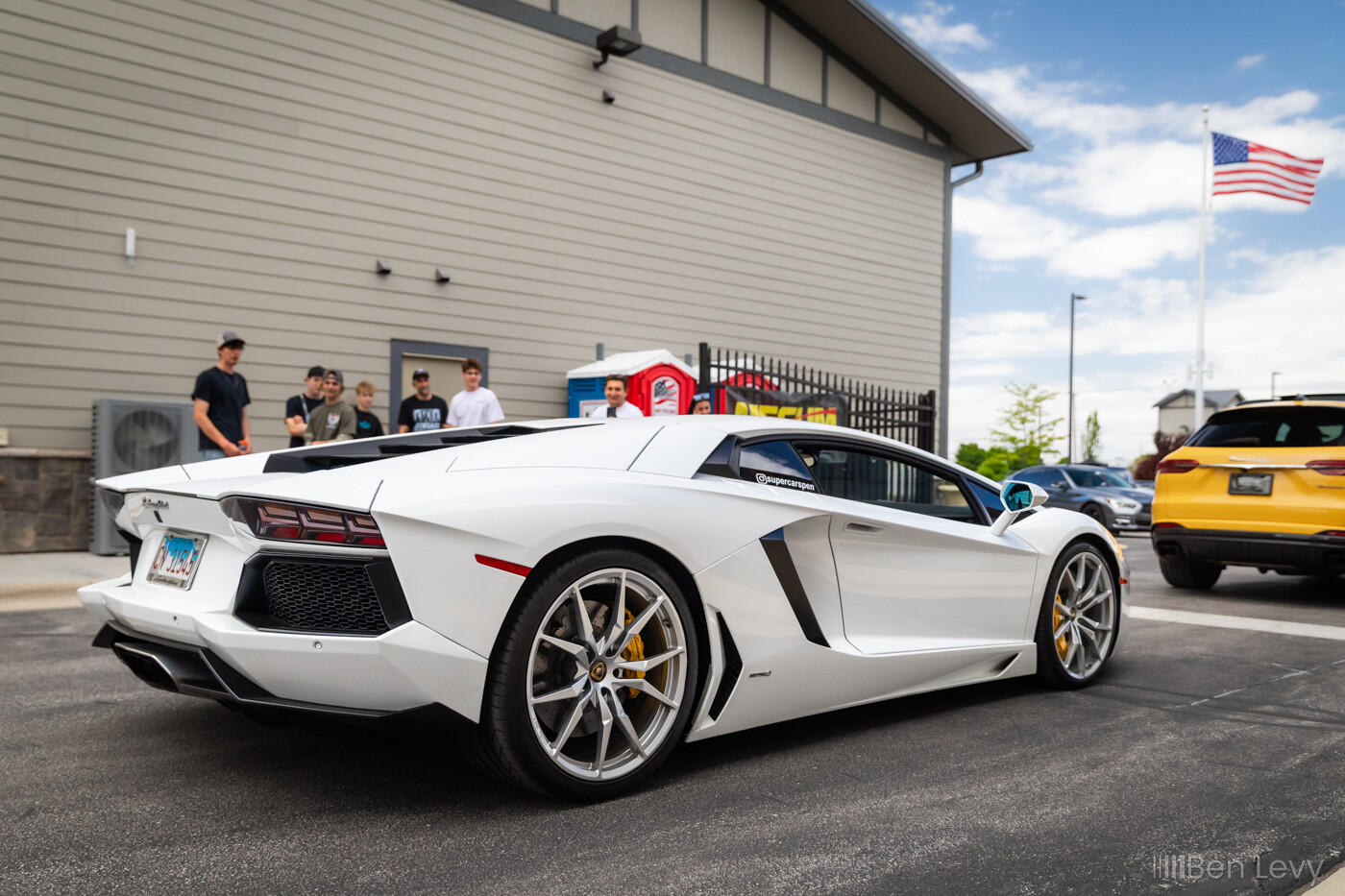 White Lamborghini Aventador leaving a car show in Naperville, IL