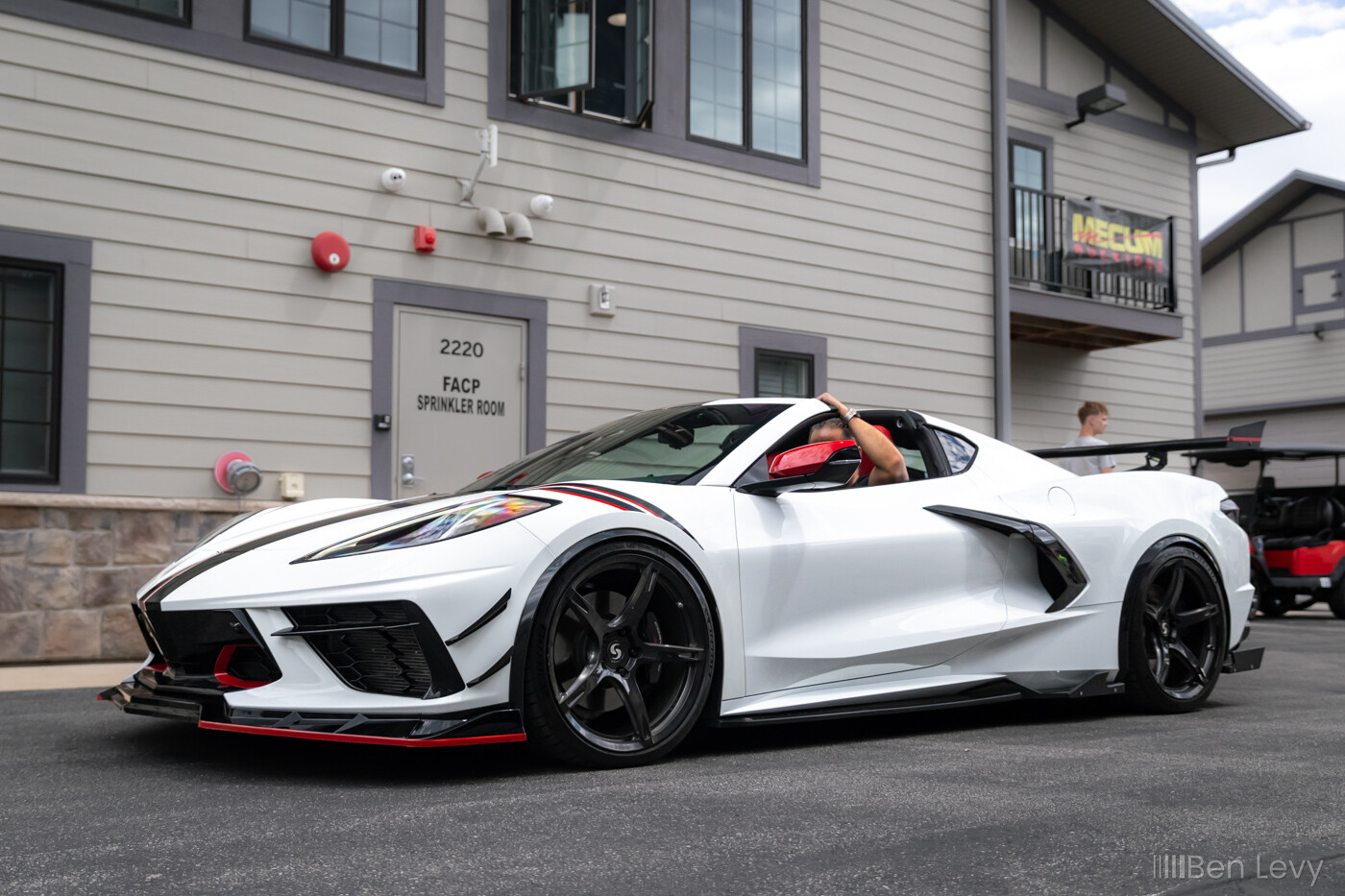 White C8 Corvette Leaving a car show at Iron Gate