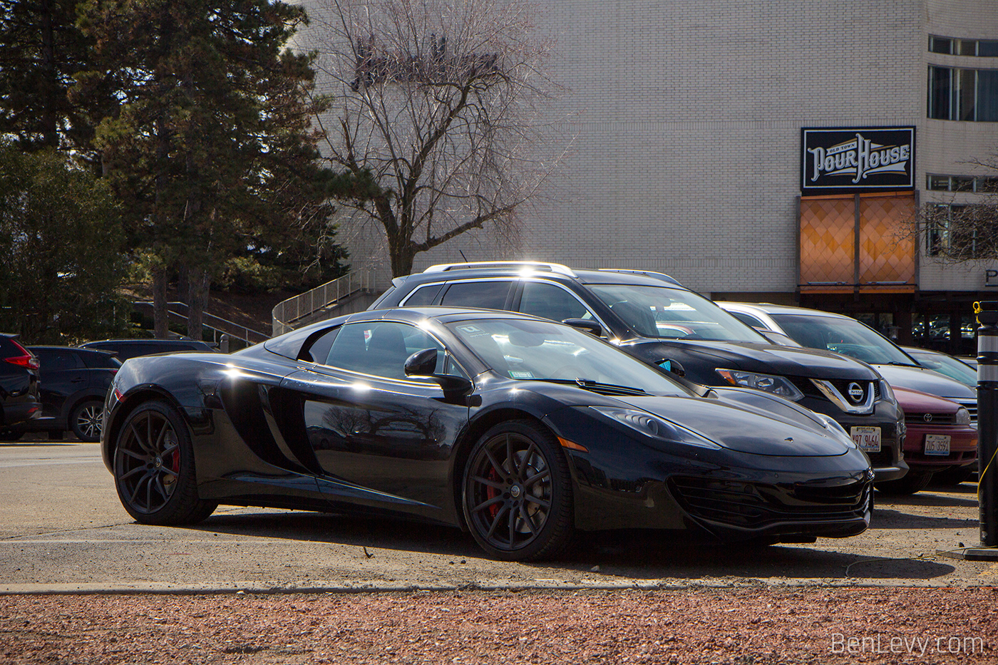 Black McLaren 12C parked in a mall parking lot