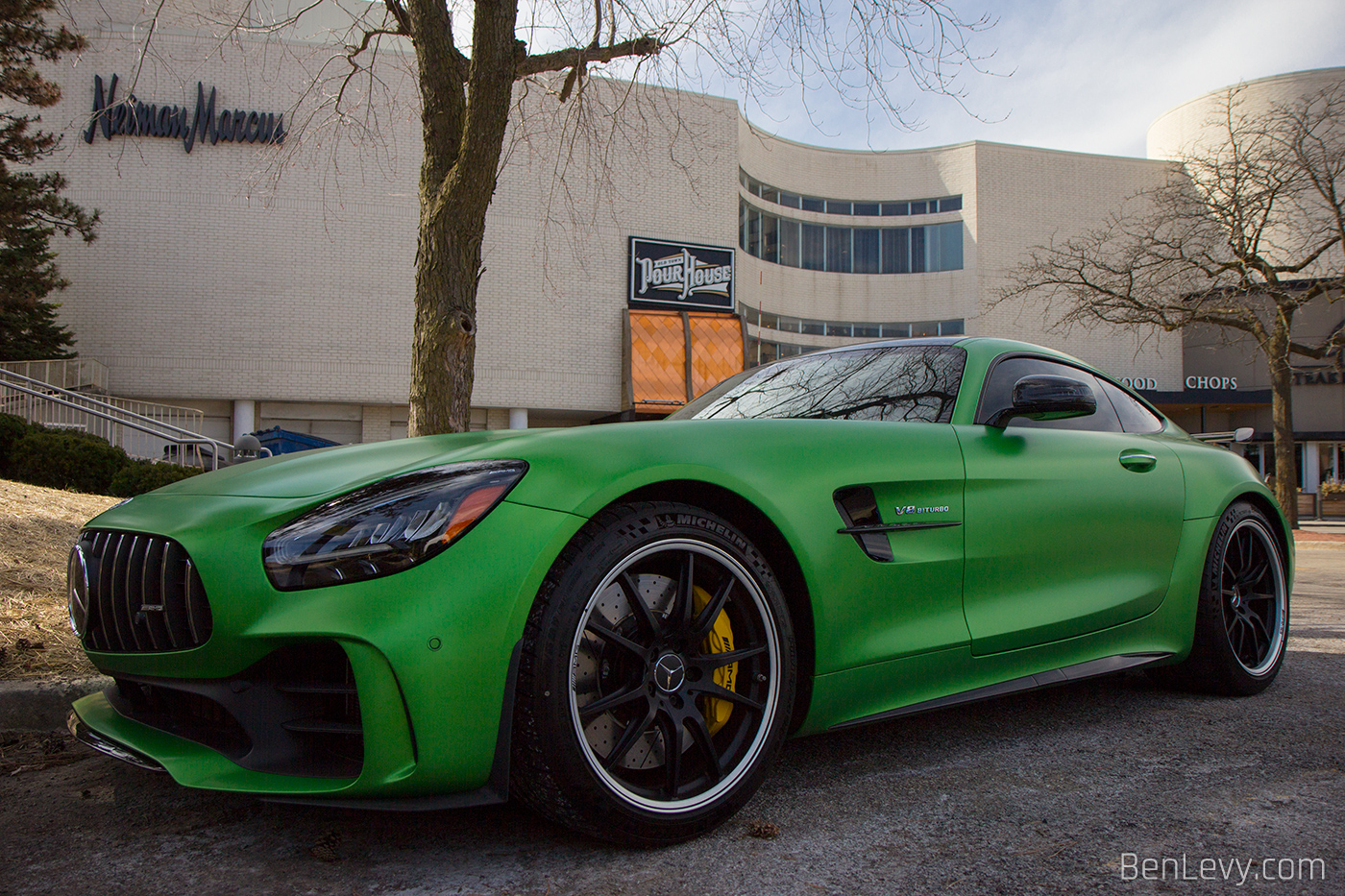 Green Mercedes-AMG GT R ourside of a mall