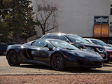 Black McLaren 12C parked in a mall parking lot