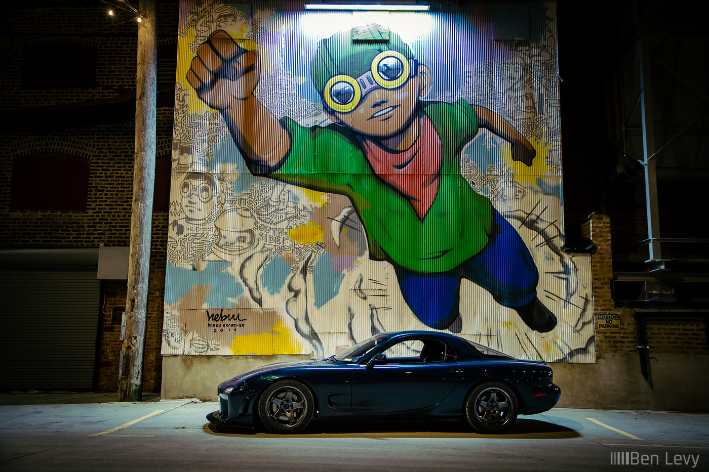 Green Mazda RX-7 in front of Flyboy Mural