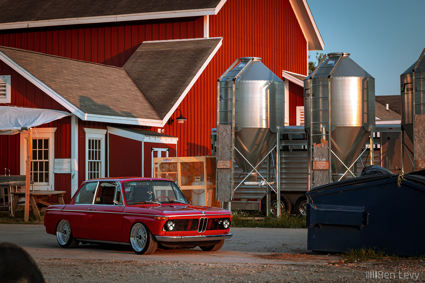 Red BMW 2002 Parked Behind a Farmhouse