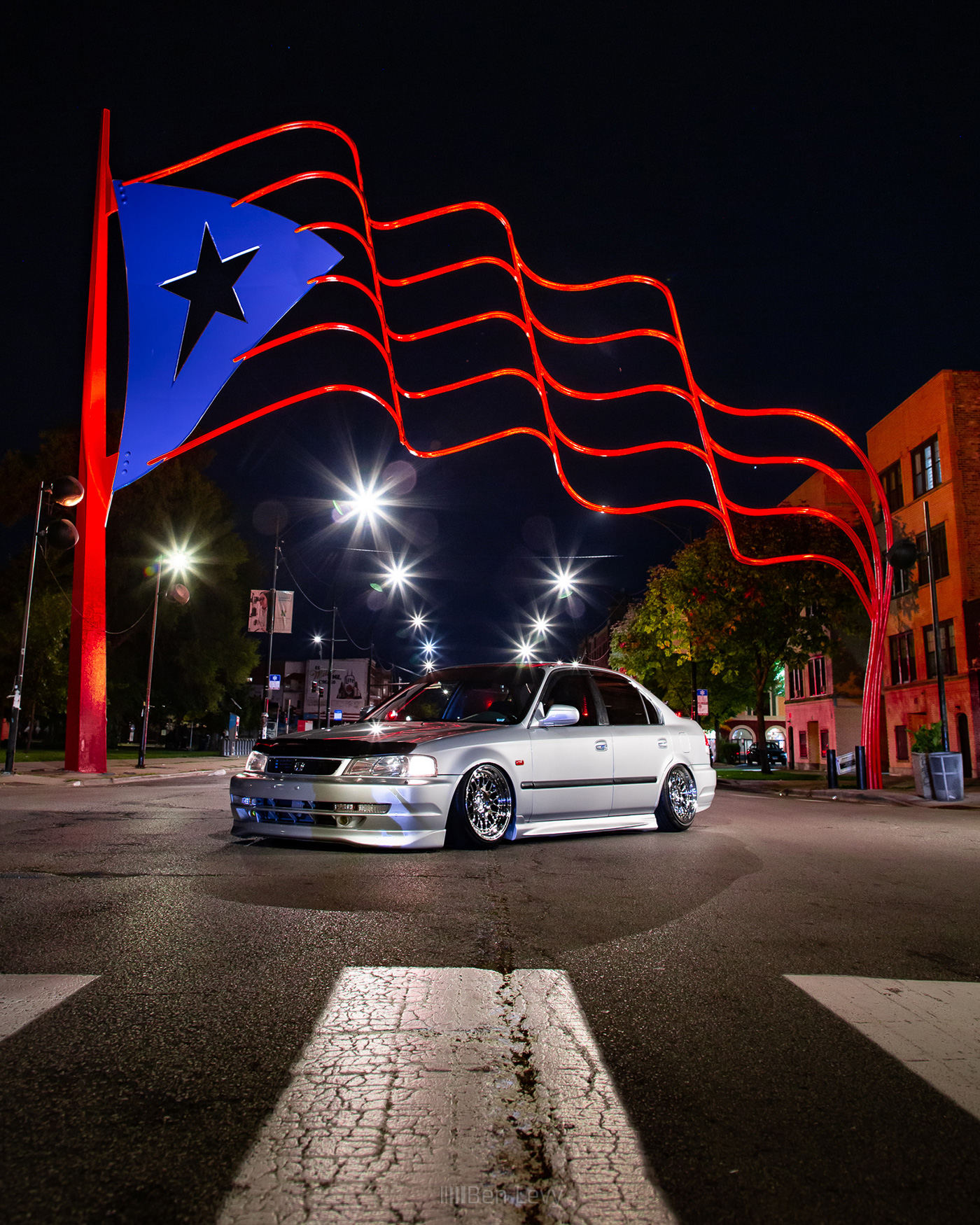 Silver Civic with Honda Domani Conversion under Puerto Rican Flag on Paseo Boricua