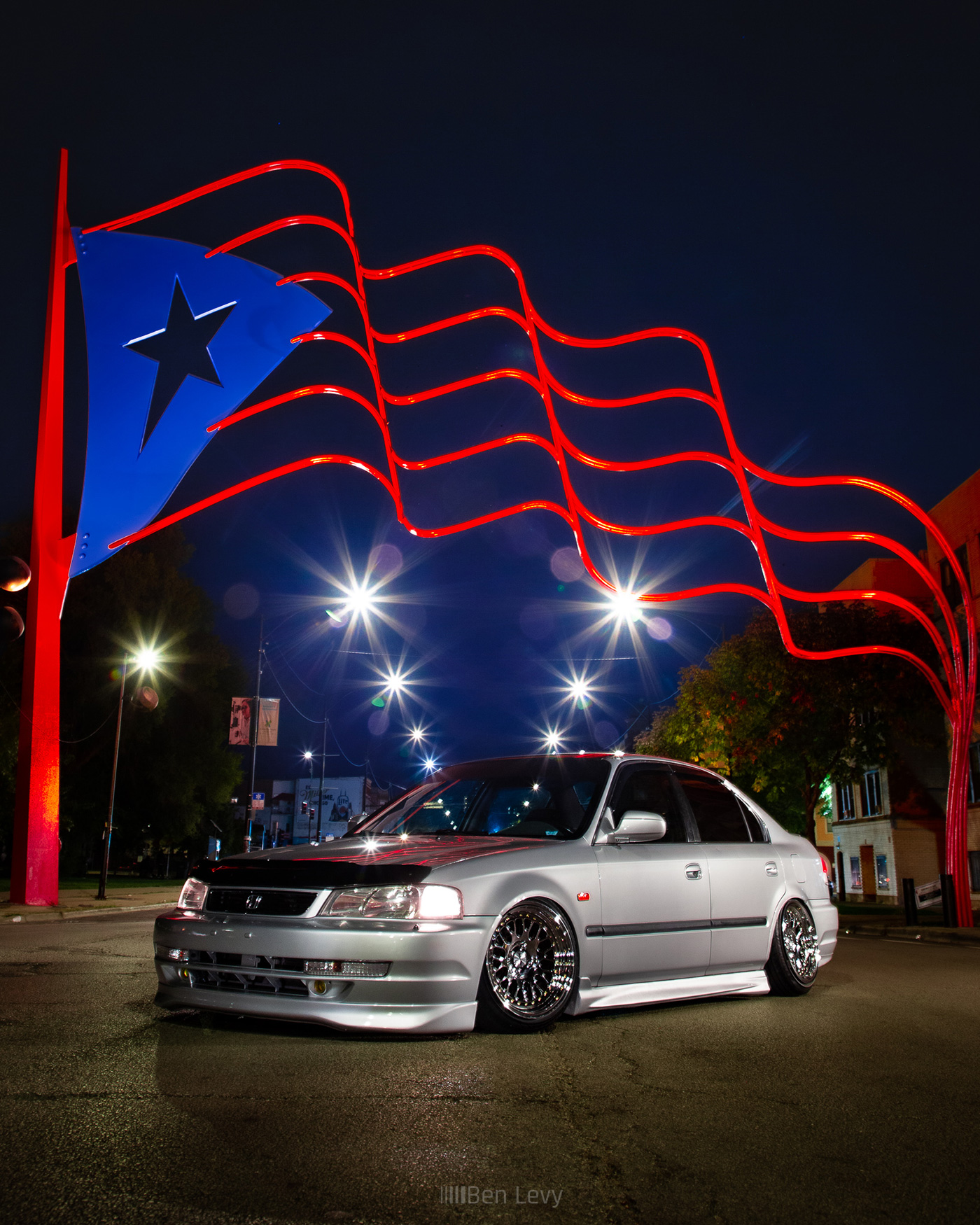 Silver Honda Civic Under Puerto Rican Flag on Division in Chicago