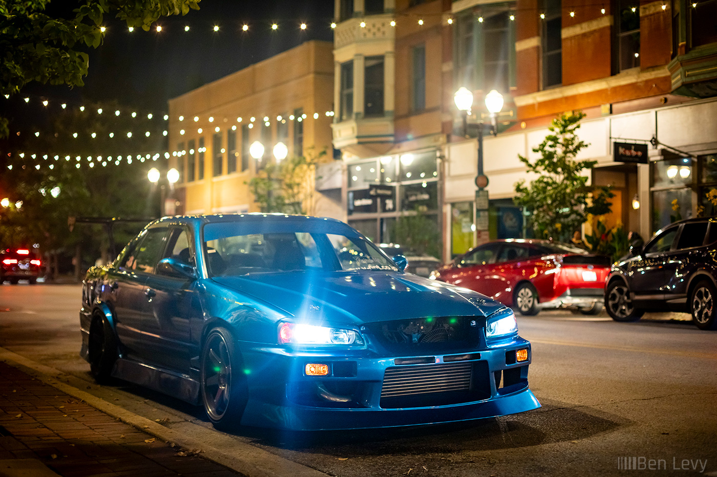 Blue R34 Nissan Skyline Sedan in Downtown Elgin, IL at Night
