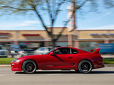 Red Toyota Supra passing on the street