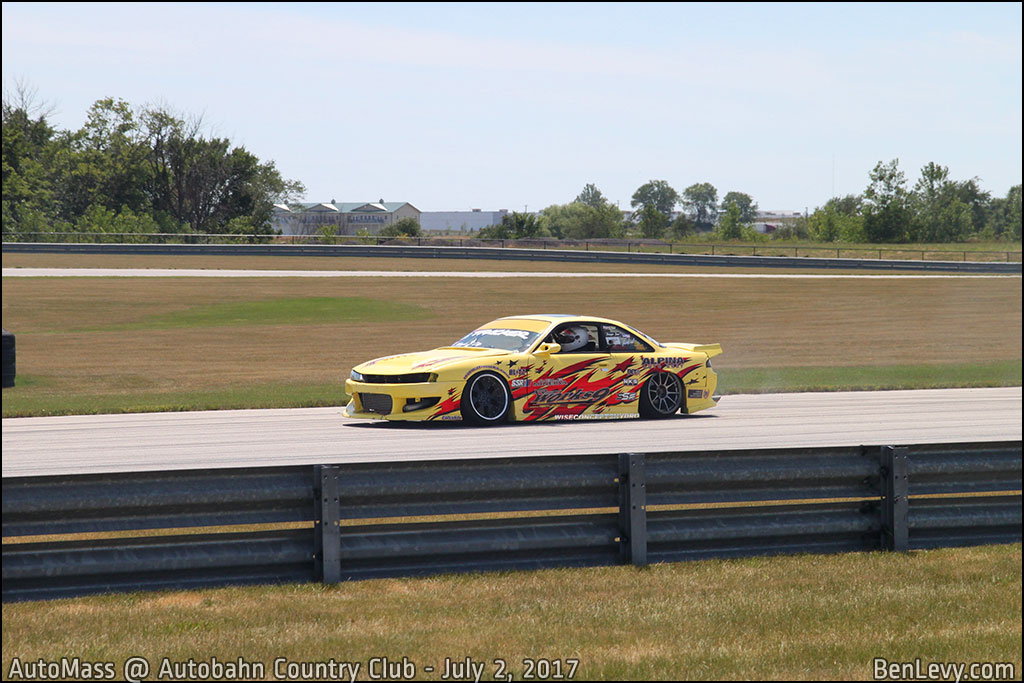 Yellow S14 240SX on the track at Automass