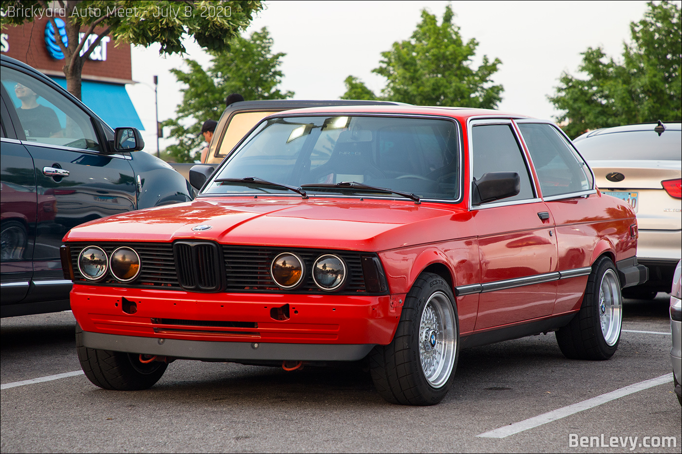 Red BMW 320i with front bumper removed