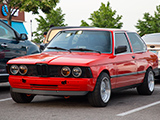Red BMW 320i with front bumper removed
