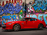 Red R35 Nissan GT-R in front of Graffiti Wall