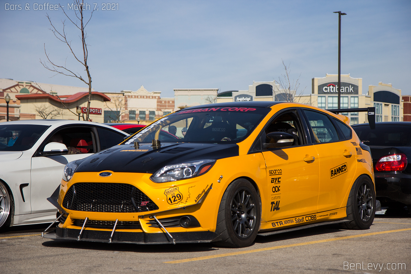 Yellow Ford Focus ST with Seban Corp sticker