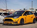 Yellow Ford Focus ST with Seban Corp sticker
