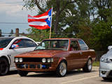 Brown Corolla Coupe with Puerto Rican Flag