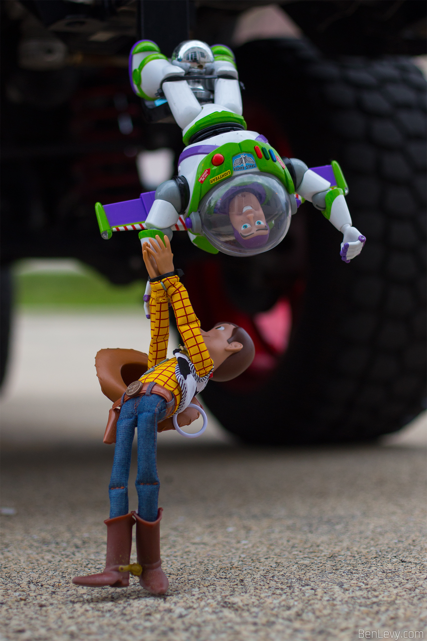 Buzz and Woody hanging off a Jeep