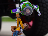 Buzz and Woody hanging off a Jeep
