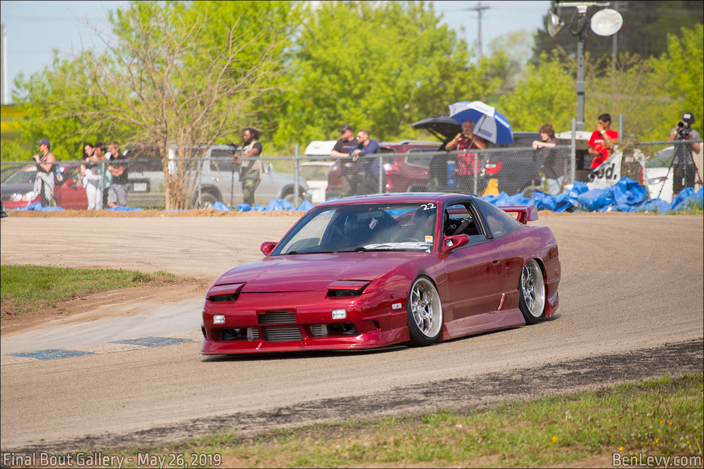 Red Nissan 240SX on the track